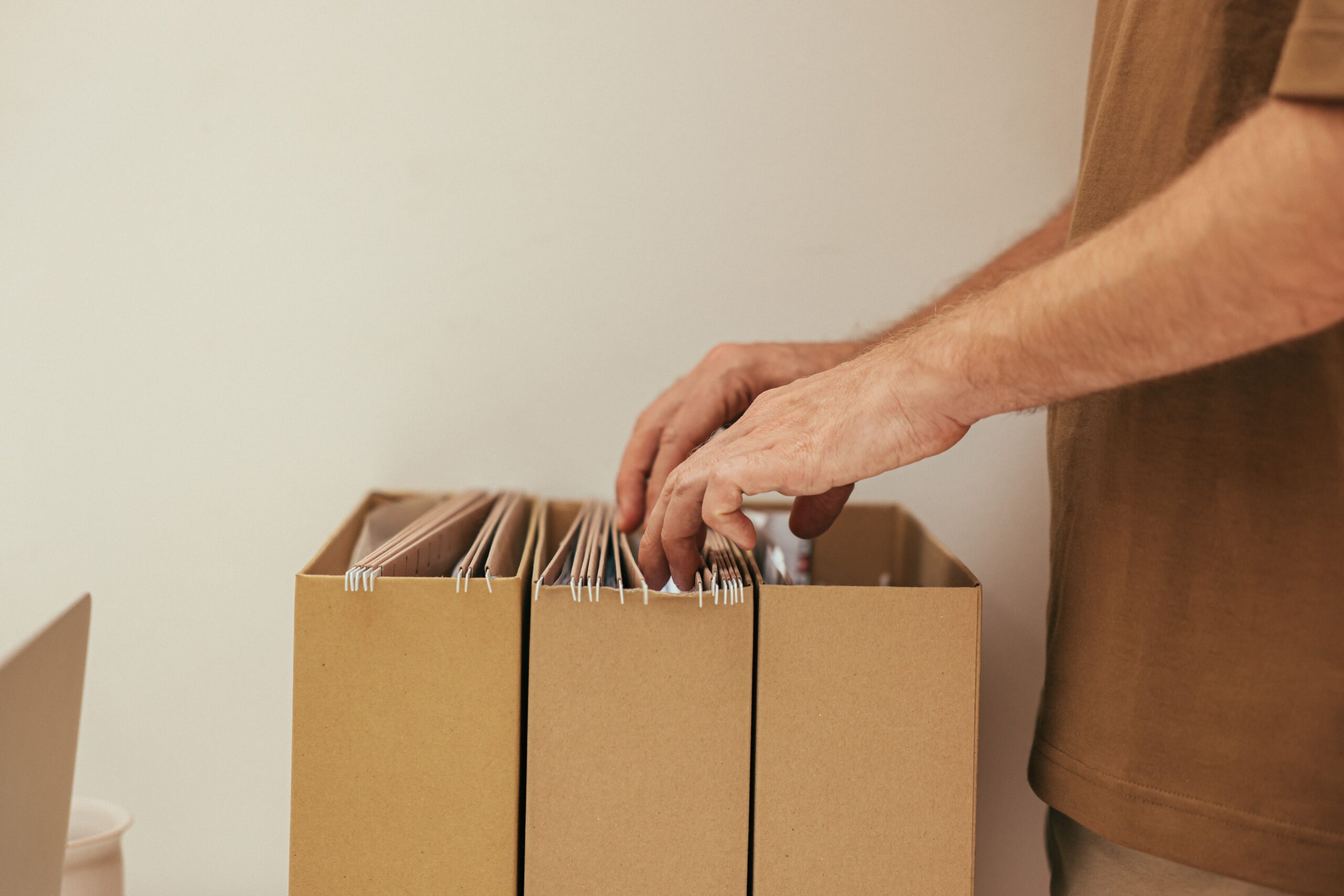 Close-up of a person organizing documents and a checklist before applying for health insurance